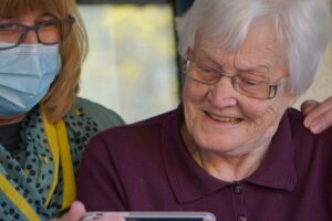 elderly woman viewing a mobile phone screen